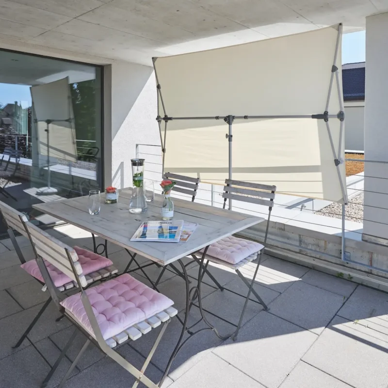 Parasol vertical de balcon inclinable Flex Roof utilisé comme brise-vue sur une terrasse.
